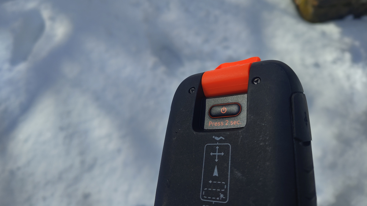 El botón de encendido está situado en la parte trasera, protegido con la pestaña naranja, abierta en esta imagen.